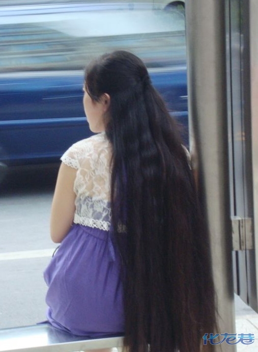 Long hair girl waiting in bus station in Changzhou city, Jiangsu province -  []