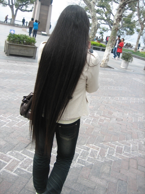 Long hair girl took photos by mobilephone