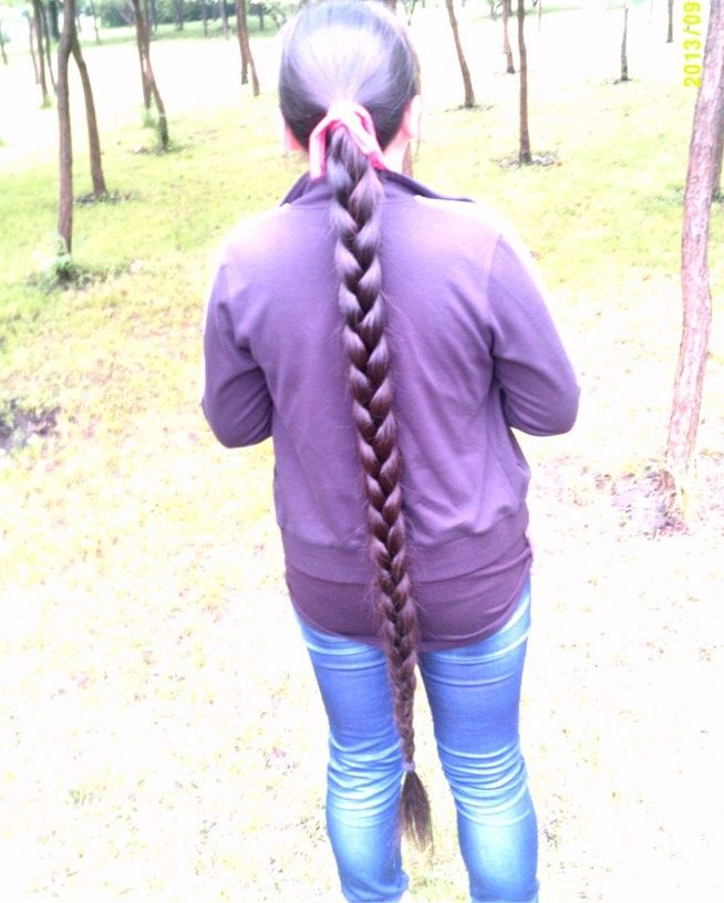 Thick long braid of young student