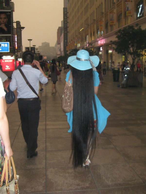 Chen Juan walked with floor length long hair on street