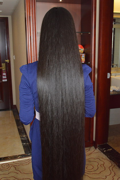 Beautiful young girl show floor length long hair in hotel