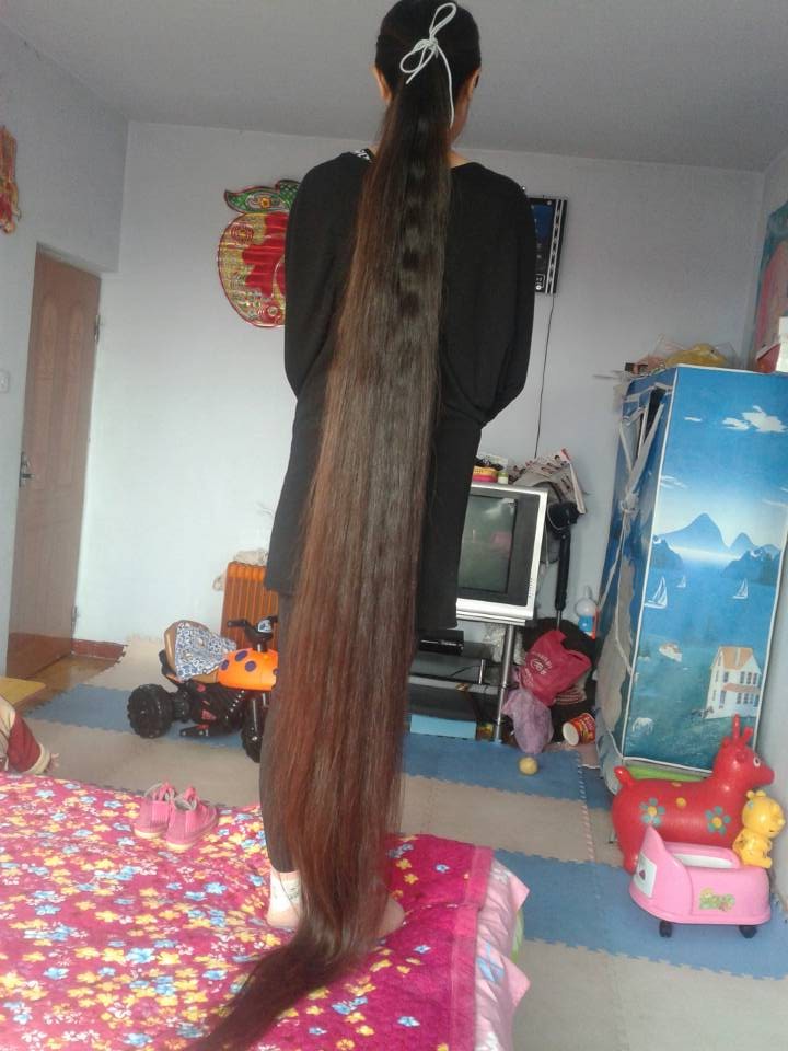 Young mother show super long braid and ponytail in home