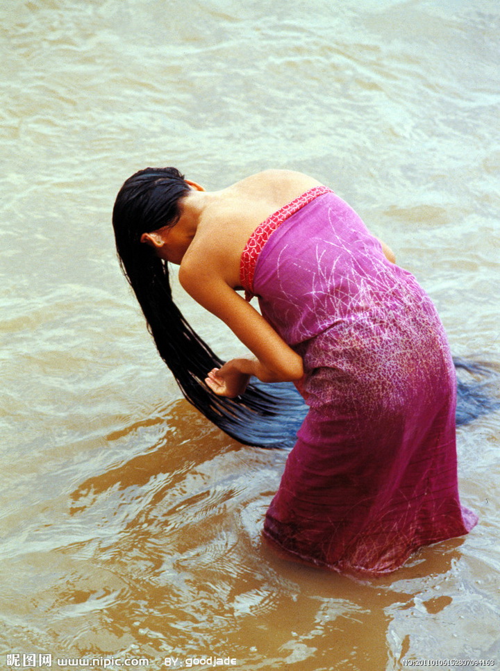Beautiful lady wash super long hair in river