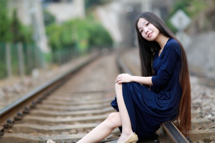 Beautiful girl show long hair on railway