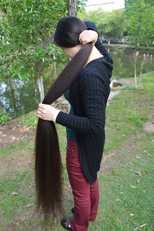 She hold her floor length long ponytail