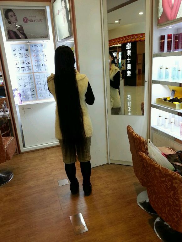 Knee length long hair lady in front of mirror