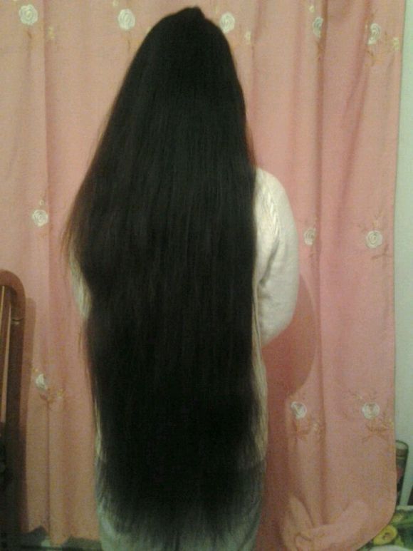 Young girl has thick hip length long hair