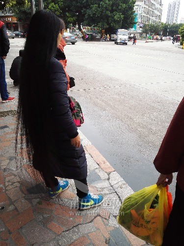 A lady from Fujian province has almost floor length long hair