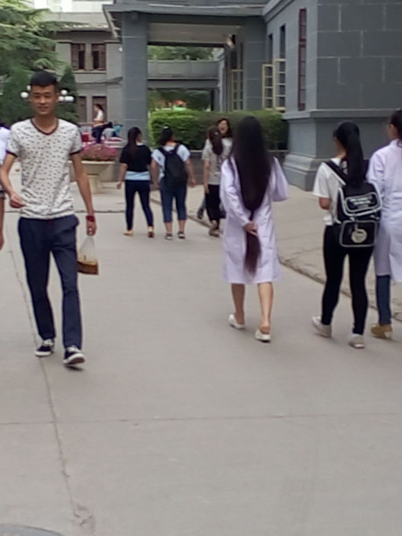 Knee length long hair university student in Gansu province