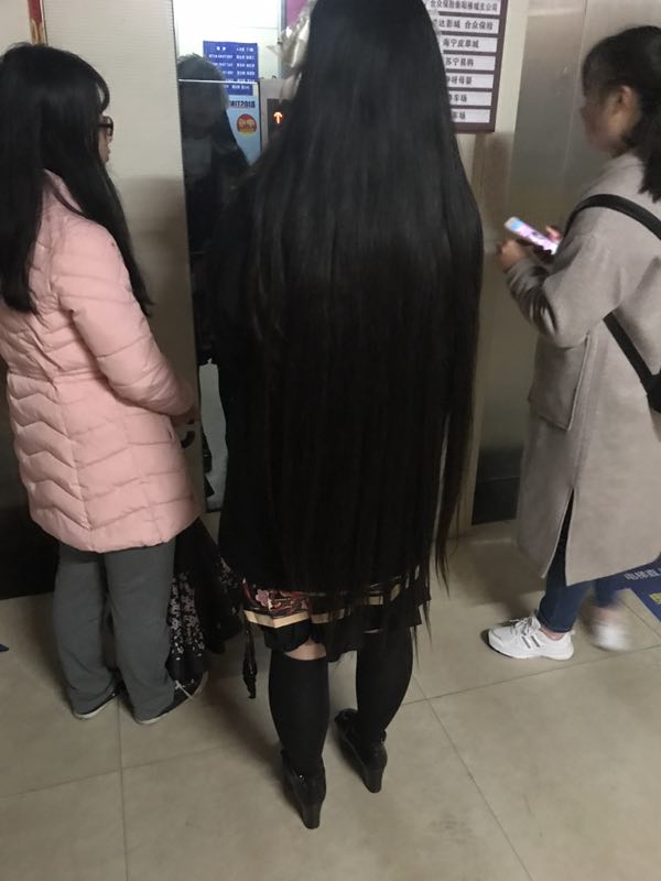 Long hair girl waiting for elevator
