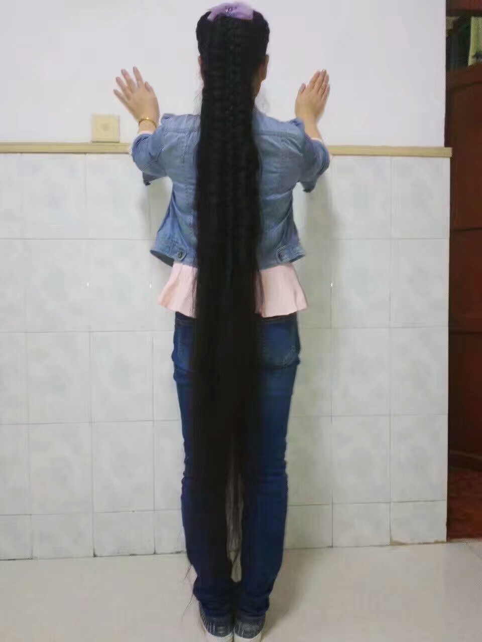 Young girl with ankle length long braid