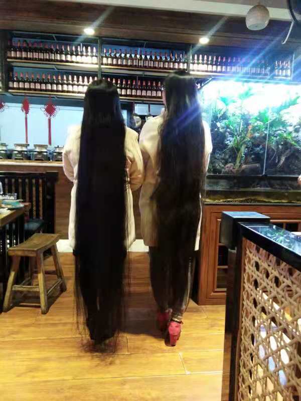 2 super long hair ladies take photos in restaurant